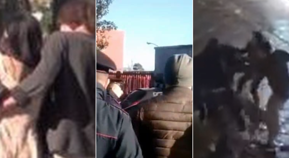 Bacia una donna davanti al marito