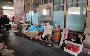 Il clochard con casa dietro la spazzatura