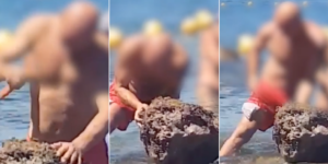 Spacca una roccia per prendere i datteri di mare